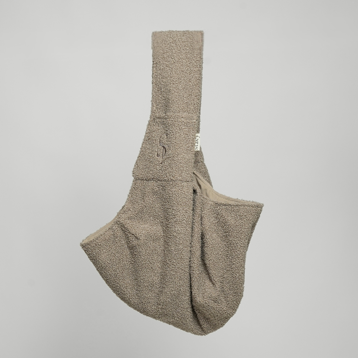 Beige teddy sling carrier for small dogs, seen from the side