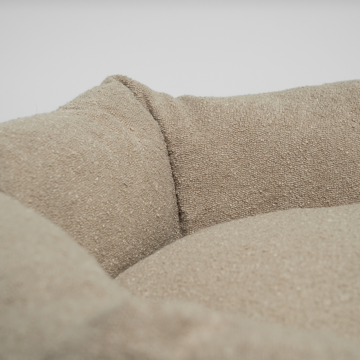 Close-up of the bolster and cushion on the oat bouclé Luna dog bed