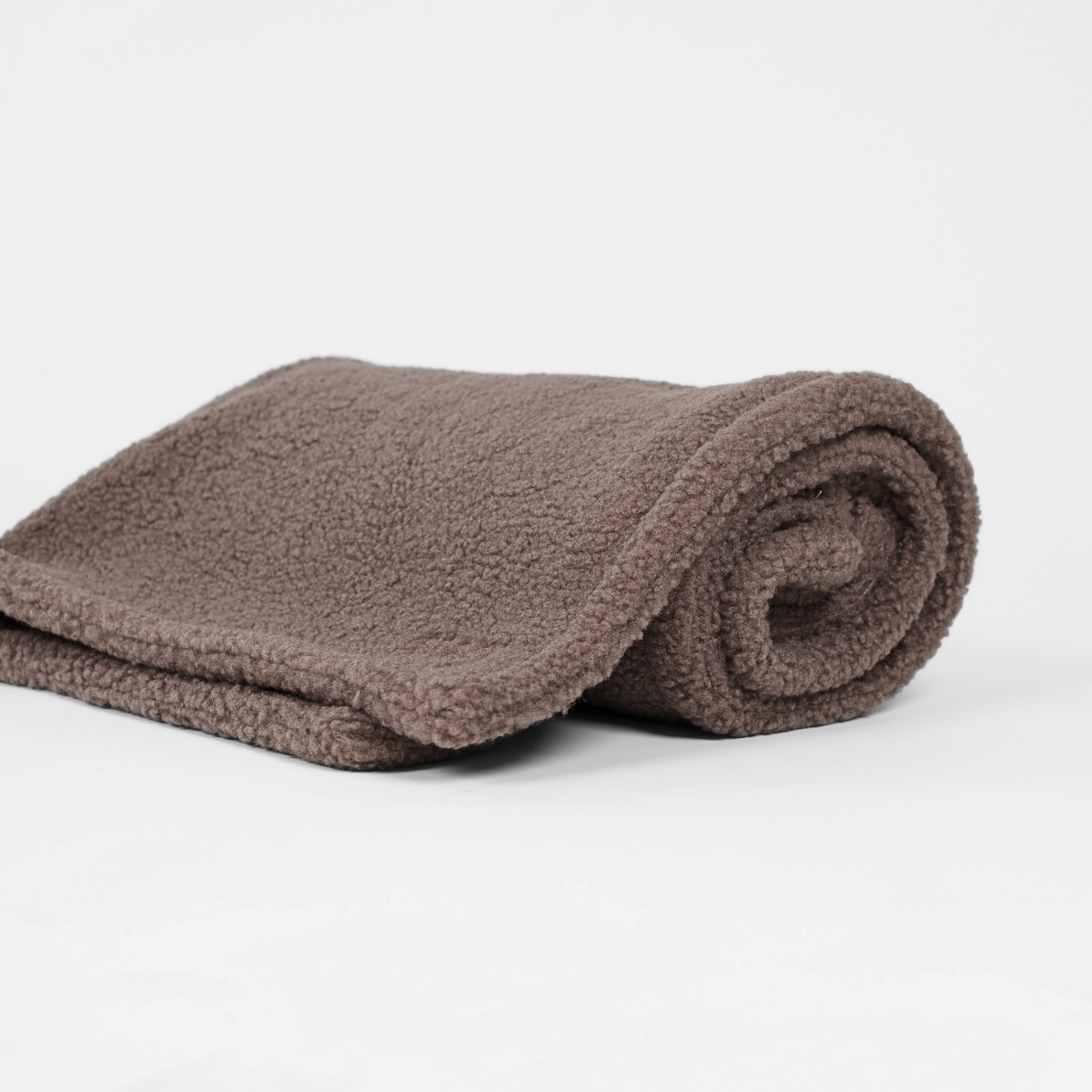 The taupe teddy dog blanket rolled up