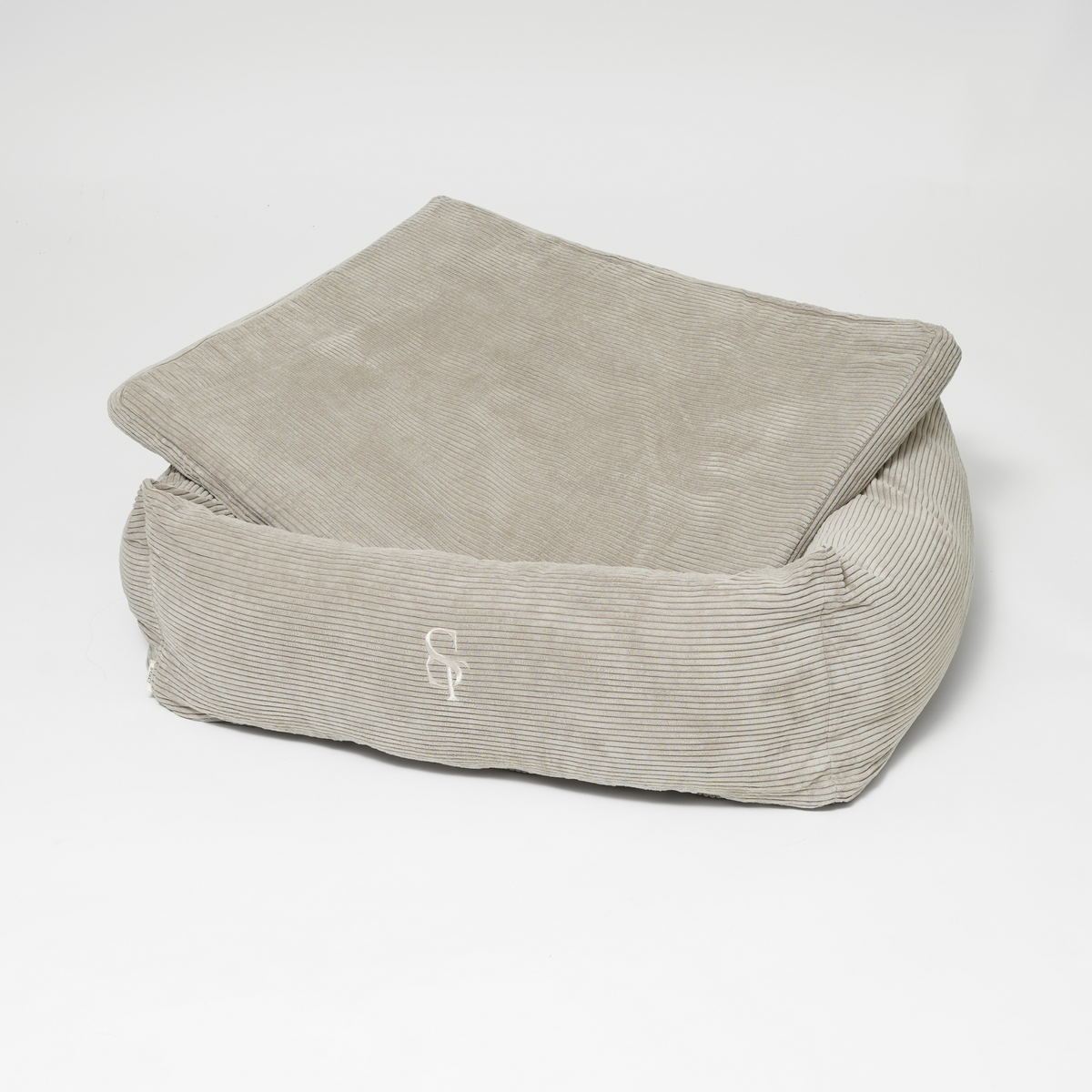 Le lit pour chien rectangulaire en velours côtelé taupe, avec son coussin relevé