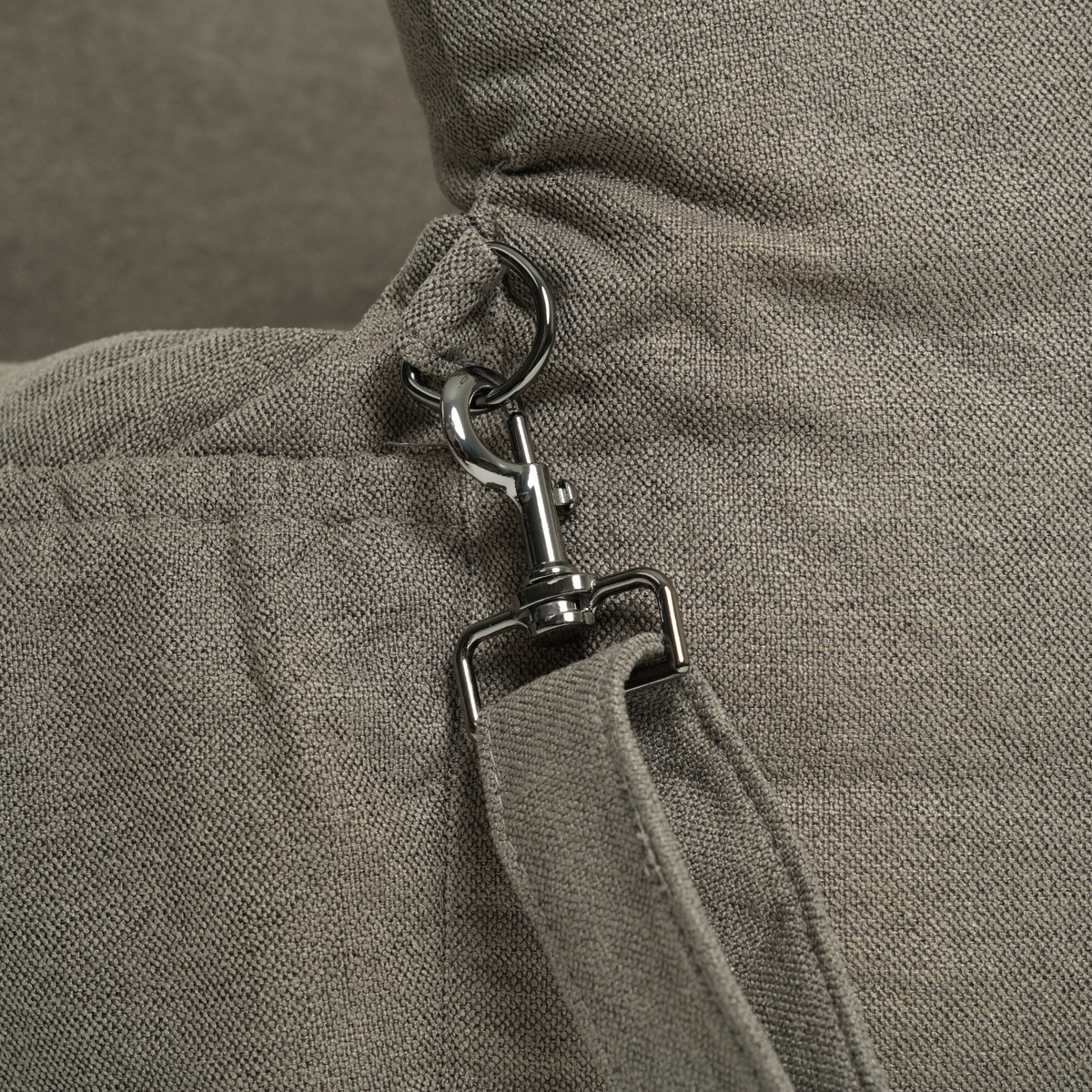 Close-up of the safety leash on a moss green dog car seat